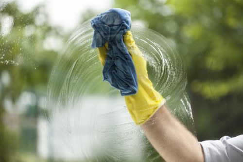 Cleaner sanitizing desks and high-touch surfaces in an office